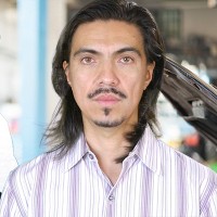 Henry Butler Man with long dark hair and dark facial hair